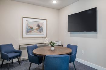 A room with a round table and four chairs.